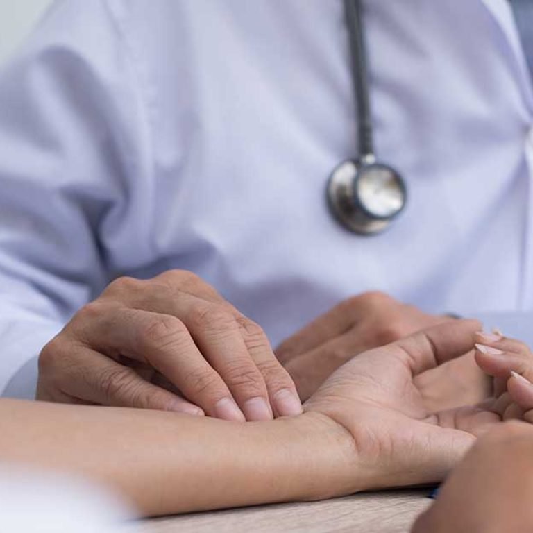 doctor-taking-patients-pulse-outpatient-department